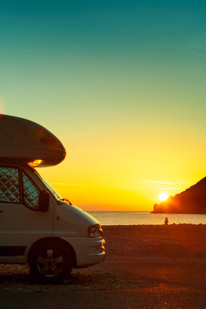 istock Camper car on nature at sunrise. Travel 2149986842