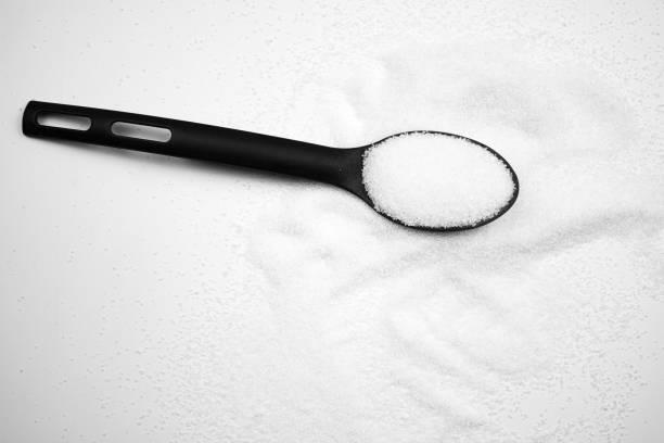 Spoonful of sugar. Sugar, additive, ingredient on white background.