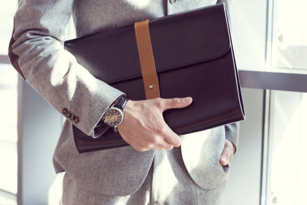 istock Businessman wearing suit holding briefcase 2149987023