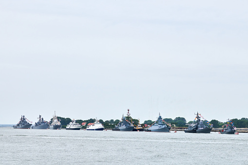Military parade of Russian naval forces warships along coastline, seafaring tradition of military ships formation along shore, nautical spectacle of russian sea power