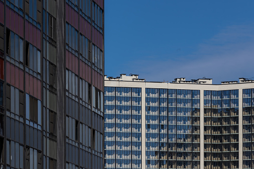 High-rise residential apartment buildings of dense development with a large number of windows and balconies