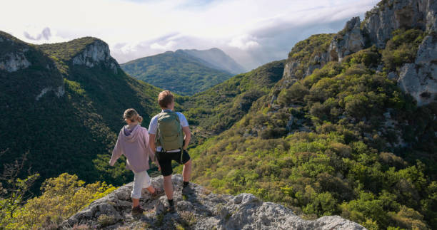 istock Friends look across mountains and valley from viewpoint 2149990953