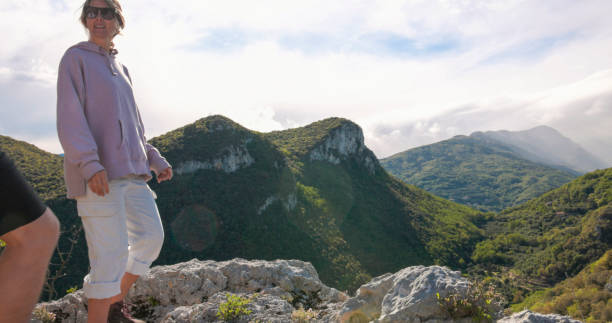 istock Friends look across mountains and valley from viewpoint 2149990955