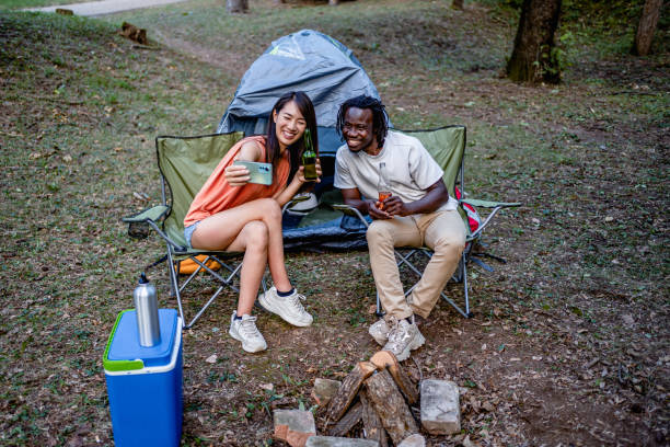 istock Friends enjoying while camping in the forest together 2149992427