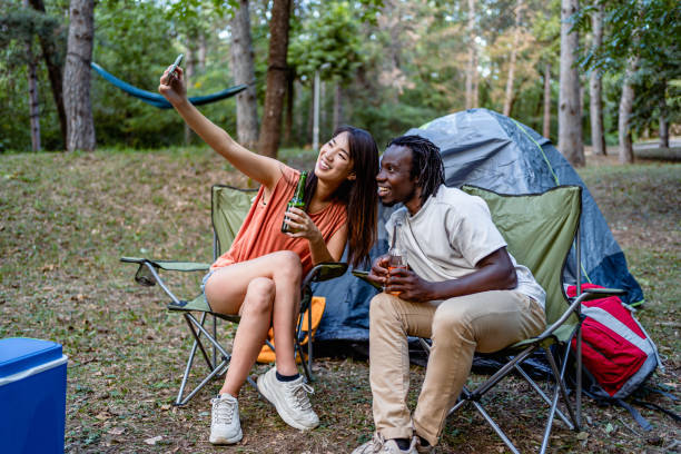 istock Friends enjoying while camping in the forest together 2149992489