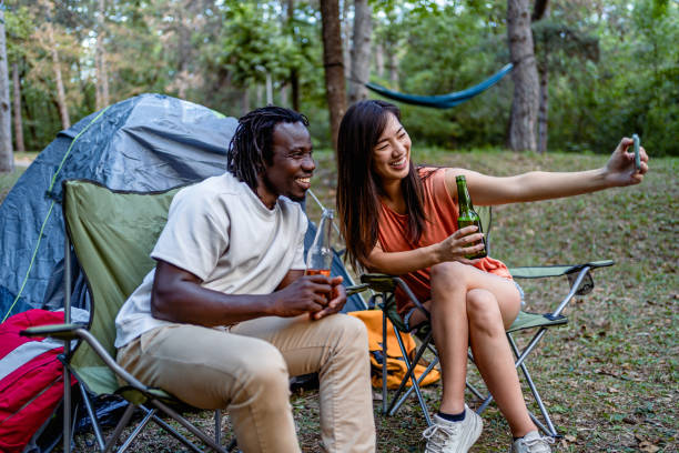 istock Friends enjoying while camping in the forest together 2149993104