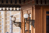 Pair of white street lights on the porch of a historic building
