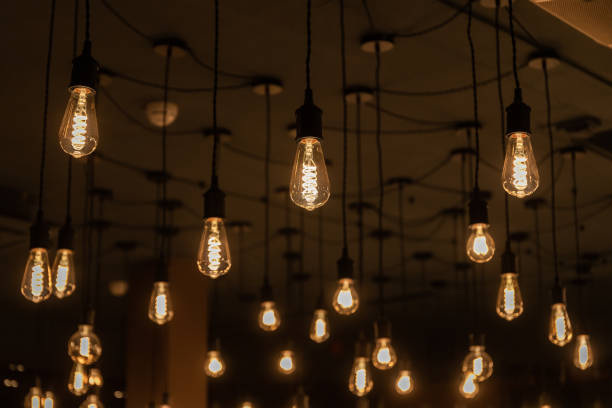 istock Many warm light incandescent lamps attached to the ceiling on a wire 2149995136