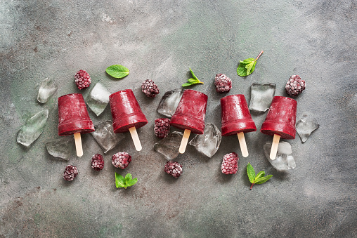 Berry popsicles. Summer refreshing cooling dessert. Fruit ice on a stick.
