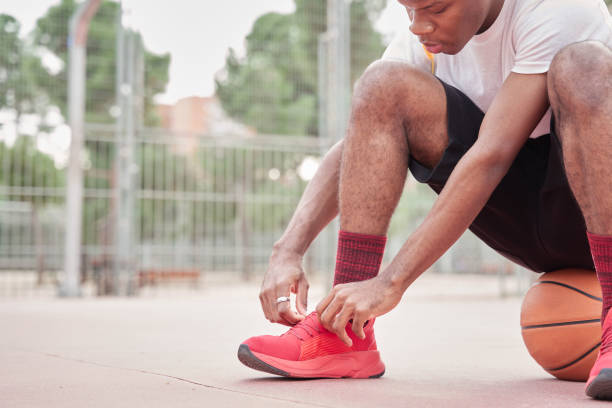 istock Young basketball player tying shoes 2149995847