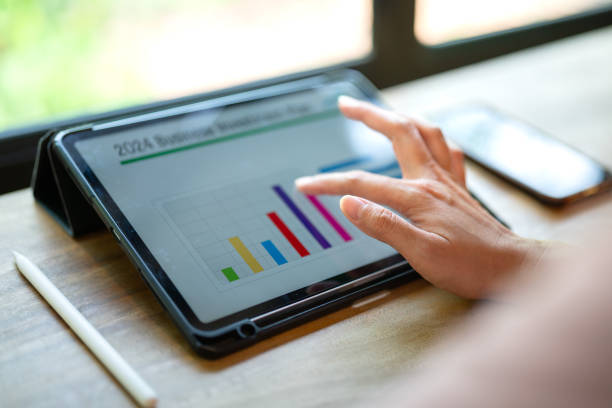 istock Working on business investment plan in tablet. 2149998144