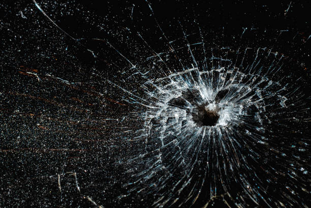 istock Bullet hole in a glass on the black background.closeup. 2149998954