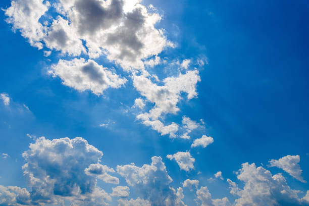 Backlit of blue sky with white clouds frame and lens flare.