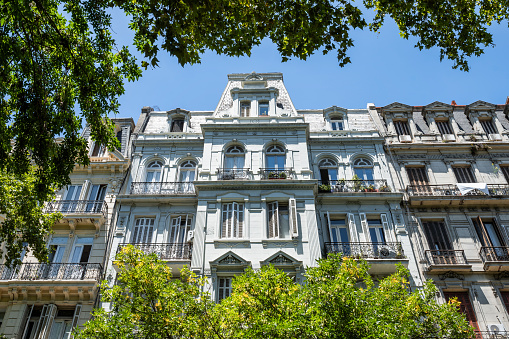 low angle view on historic residential architecture in Buenos Aires against blue sky