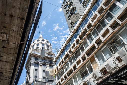 low angle view on modern and historic architecture in Buenos Aires against blue sky