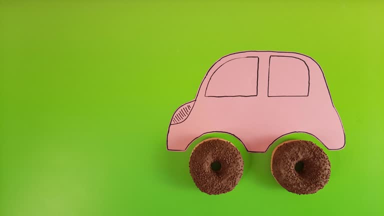 Pink retro car with donut wheels.