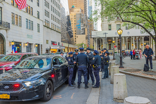 New York. USA. 04.15.2024. View of a police group on 5th Ave, NYC, with their patrol vehicle.