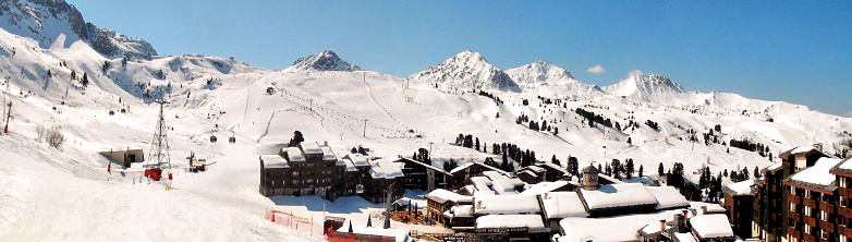 Panoramic view of the snow front and the ski area of the famous La Plagne 2000 ski resort in the heart of the French Alps in the Tarentaise valley at the foot of Mont Blanc.