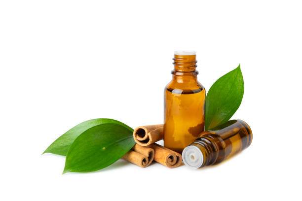 istock Cinnamon aromatic essential oil and cinnamon sticks isolated on white background. Aromatherapy. Organic cosmetic oil. Spa concept. 2150007616
