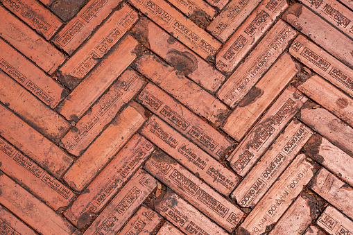 Brick floor at Hanoi University in Vietnam made of red bricks with inscriptions