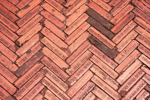 Brick floor at Hanoi University in Vietnam made of red bricks with inscriptions