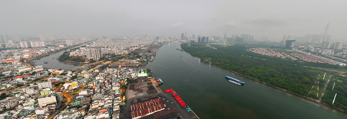 Aerial view of Ho Chi Minh city, Vietnam, beauty skyscrapers along river light smooth down urban developmen