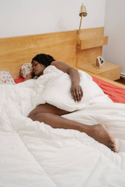 istock Woman sleeping in bed closed eyes 2150009807