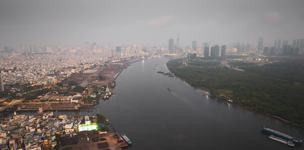 Aerial view of Ho Chi Minh city, Vietnam, beauty skyscrapers along river light smooth down urban development