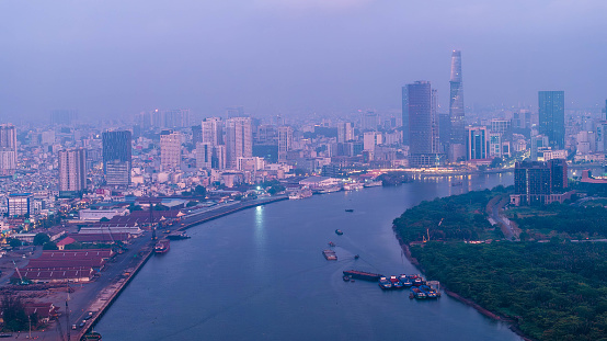Aerial view of Ho Chi Minh city, Vietnam, beauty skyscrapers along river light smooth down urban development