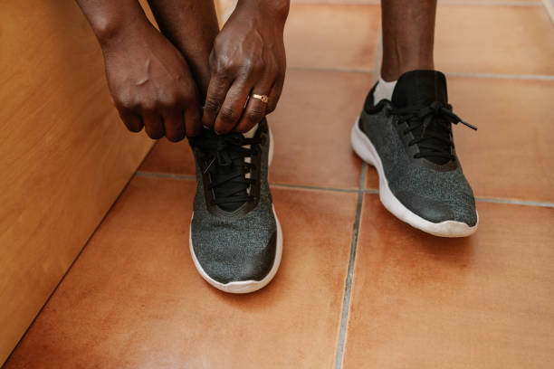 istock Unrecognizable woman putting on sneakers 2150010006