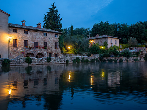 Sunrise at Bagno Vignoni, a village nestled in the Val d'Orcia a few kilometres from Siena, where there is a large medieval stone pool where the water gushes out smoking from the thermal spring