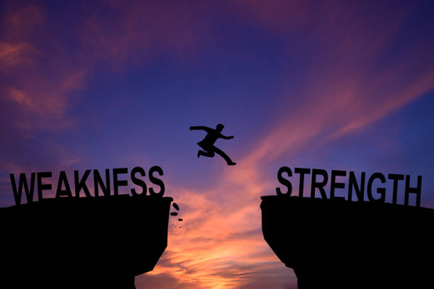 istock Man jump through the gap between hill. Weakness and Strength. 2150013819