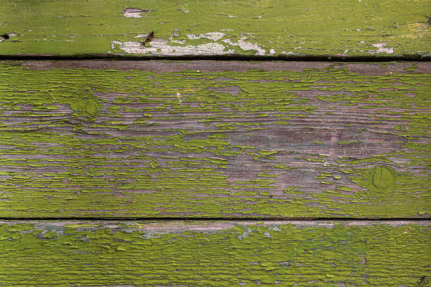 Wooden planks with old peeling green paint