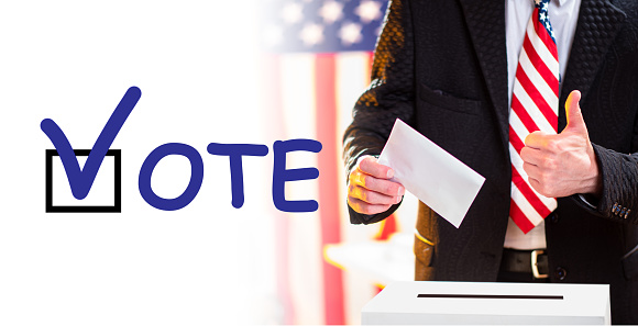 American voter shows class gesture. US presidential elections. VOTE logo next to US voter. Concept - call to participate in elections of President of America. American shows his thumb. Ballot box.
