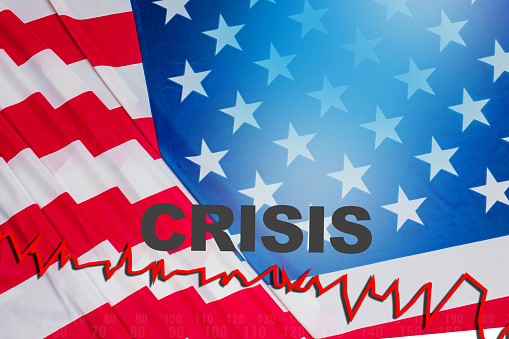 Crisis inscription on background of USA flag. Problems in US financial market. Plummeting stock market prices led to a financial crisis in America. Long-term economic crisis in United States.