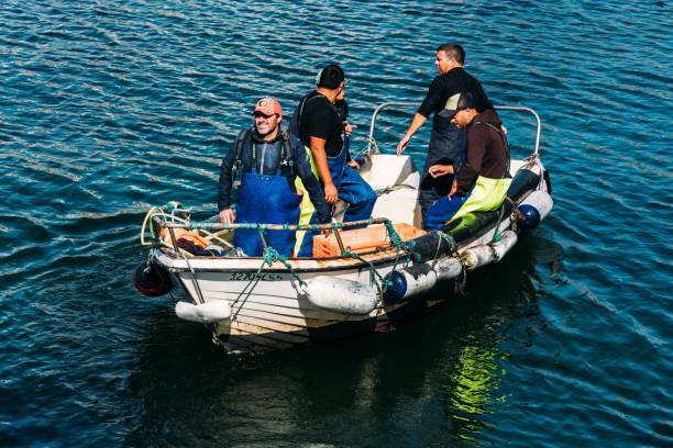 Group of happy volunteers preparing a boat for stormy weather