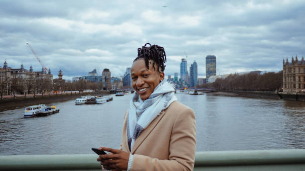 istock Cool African guy using smart phone in London 2150016257