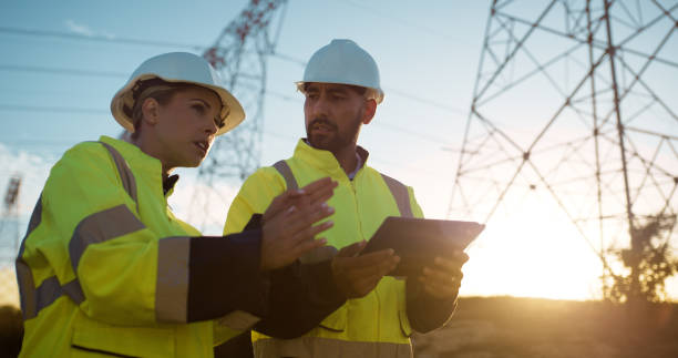 istock Outdoor, business people and people with tablet, power construction and engineering with electricity, sunshine and teamwork. Field, man and woman with technology, cooperation and planning with app 2150017019