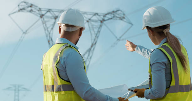 istock Construction, people and renewable energy communication with engineering and eco friendly project planning. Teamwork, sustainability and back of technician staff with tablet and solar power work 2150017437