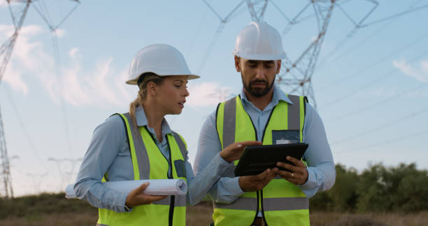 istock Teamwork, electrical engineer and inspection in power plant with tablet for electricity transmission and data transfer. Engineering, workers and collaboration for energy distribution and maintenance 2150017445