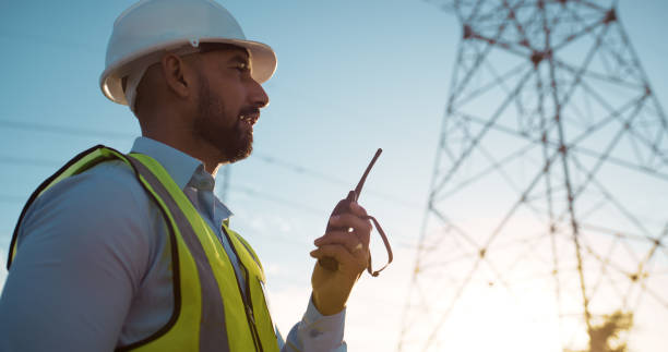 istock Man, engineer and radio with communication on site for electrical, management or outdoor construction. Young male person, technician or contractor talking for audio signal, conversation or discussion 2150018072