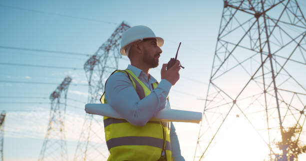 istock Man, engineer and radio with communication on site for electrical, management or outdoor construction. Young male person, technician or contractor talking for audio signal, conversation or discussion 2150018076