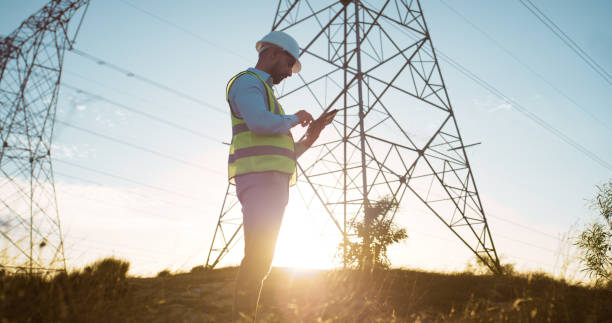 istock Man, tablet and electrical engineer with engineering in power station to test electricity transmission system or safety check. Inspector, sunset or tech app for energy distribution or turbine control 2150018077