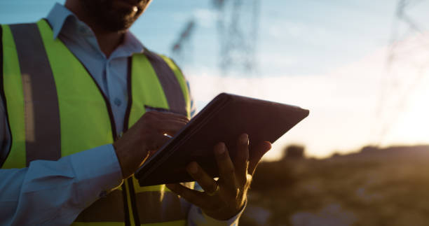 istock Man, hands and electrical engineer with tablet in power plant to test electricity transmission system or safety check. Industry worker, closeup and tech app for energy distribution or turbine control 2150018081