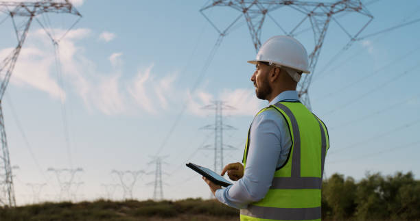 istock Man, inspection and electrical engineer with tablet in power station to test electricity transmission system or safety check. Engineering, back and tech app for energy distribution or turbine control 2150018112