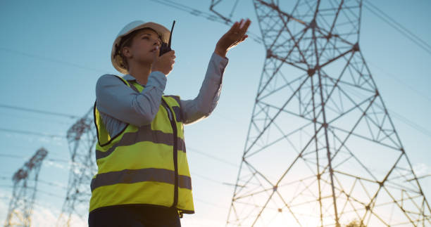 istock Woman, engineer and talking with radio on site for communication on electrical, management or outdoor construction. Female person, technician or contractor with audio signal for team conversation 2150018322