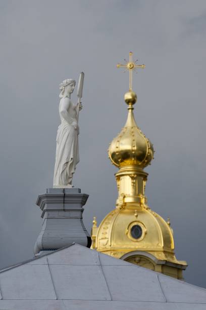 istock A statue and a golden dome against a dark sky. 2150019098
