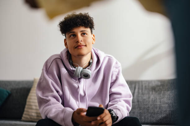 istock Young Boy with Headphones Relaxing at Home 2150019556