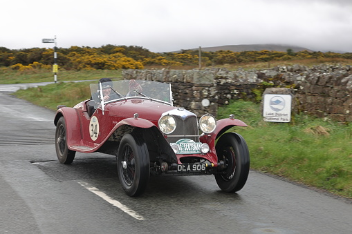 Caldbeck, England - April 13:  A 1936 Riley Kestrel leaves Caldbeck, Cumbria on April 13, 2024.  The car is taking part in the Flying Scotsman Rally, a free public-event.