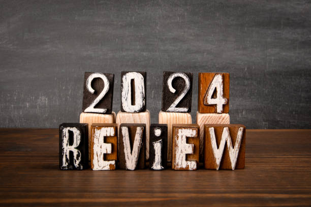 2024 Review. Alphabet blocks on wooden texture table
